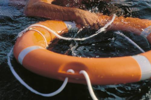 Dionisio Rodríguez, ´El Dioni´ Grabbing a float in the sea with a lifebelt vest on